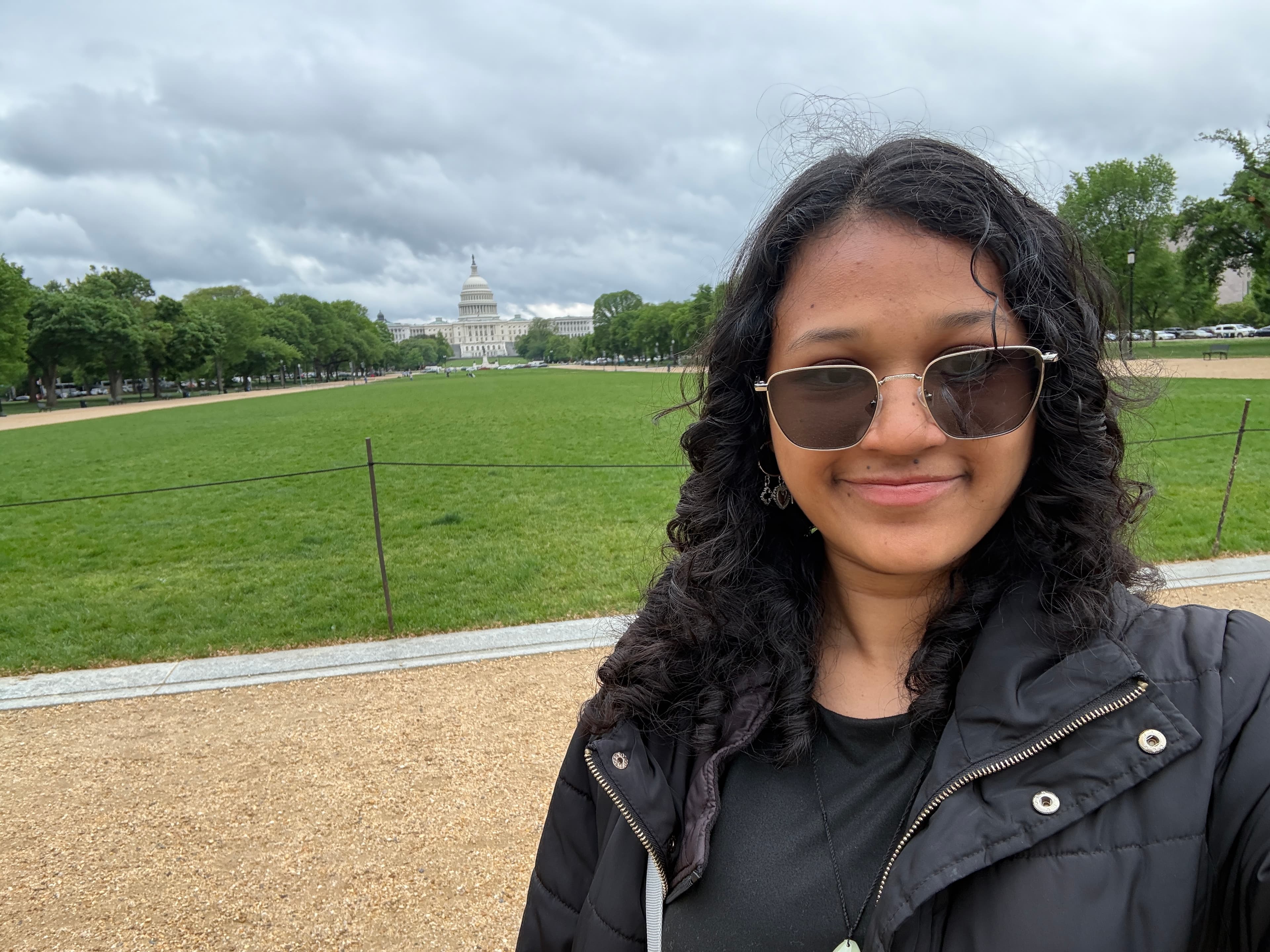 A close portrait of Shaila Lewis on the National Mall with the U.S. Capitol in the background.
