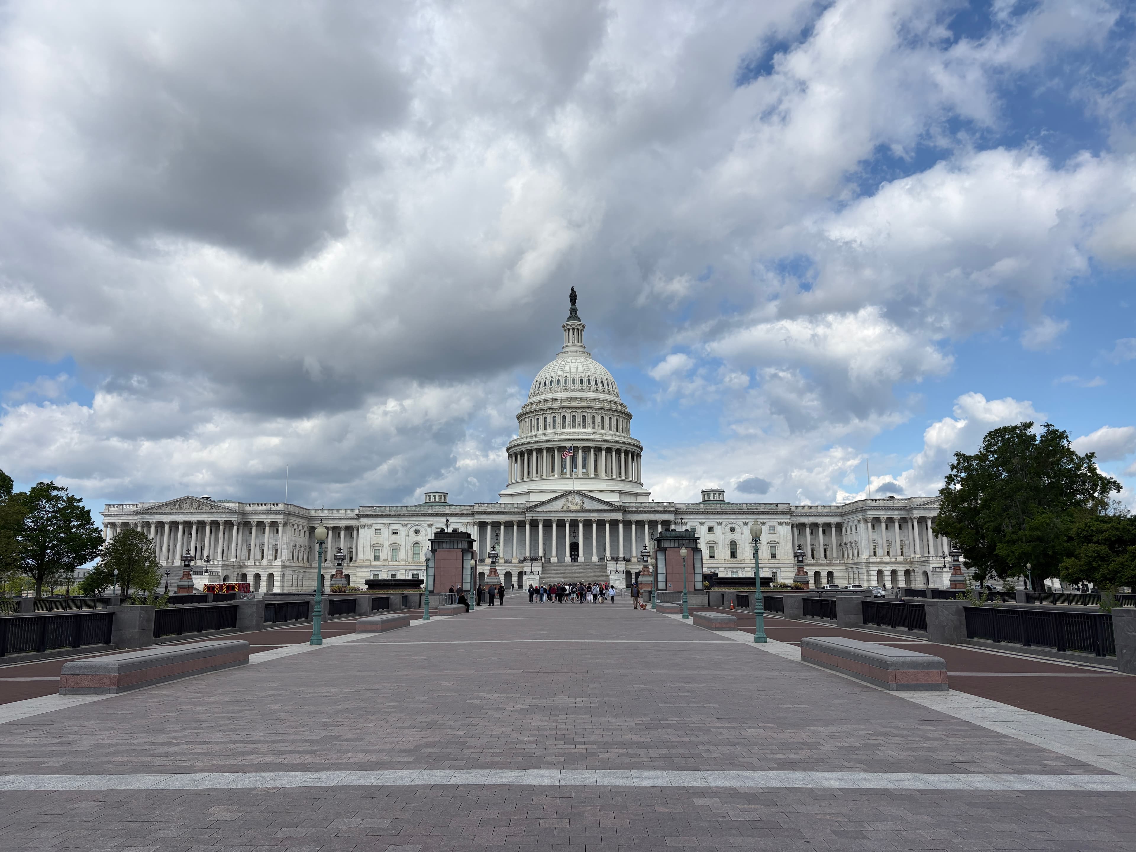A centered view of the U.S. Capitol beneath dramatic clouds in Washington, D.C.